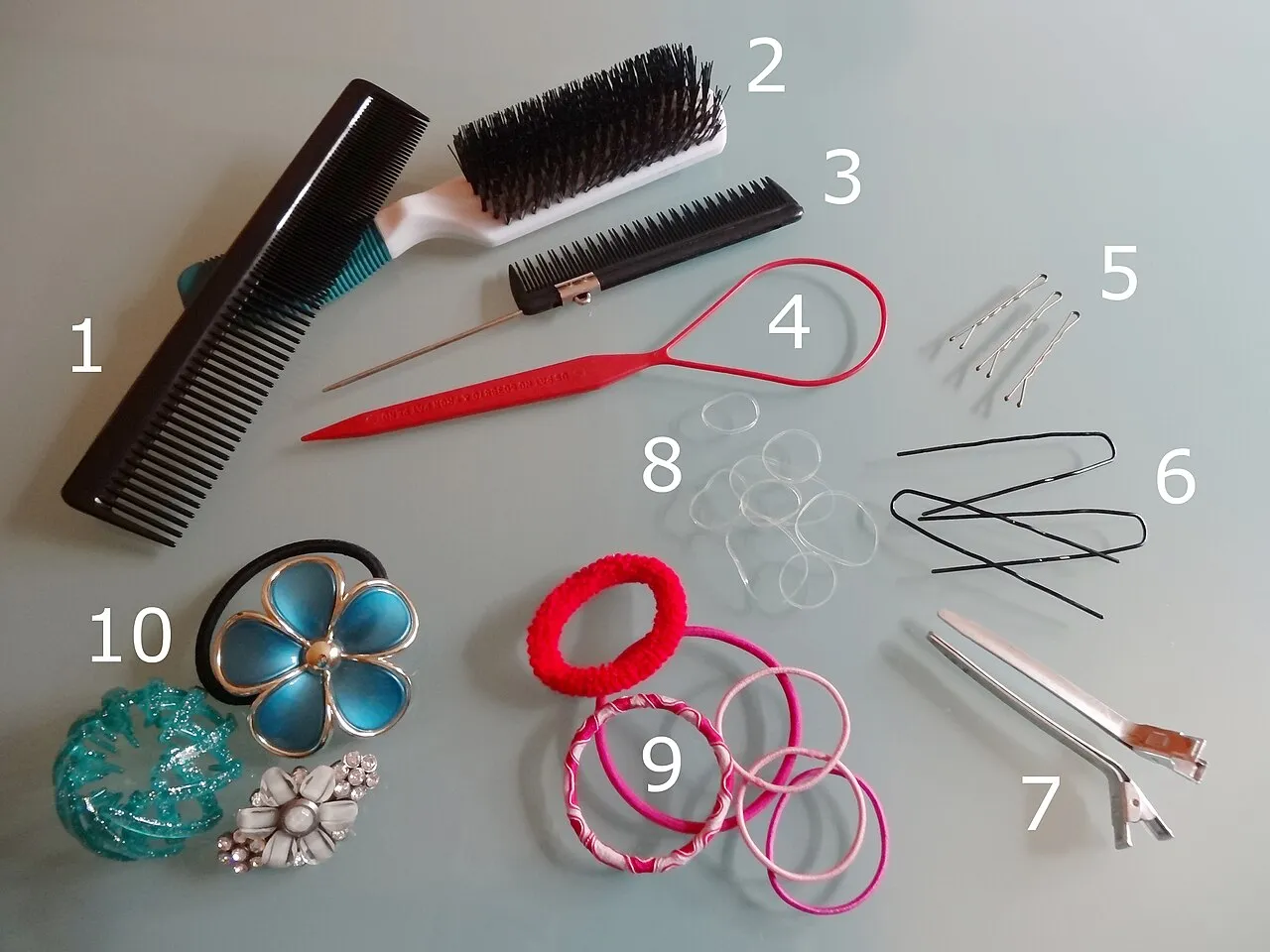Hair accessories laid out: combs, brush, clips, pins and hair ties