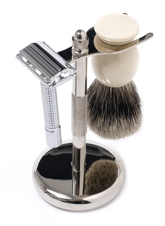 A safety razor and shaving brush on a stand