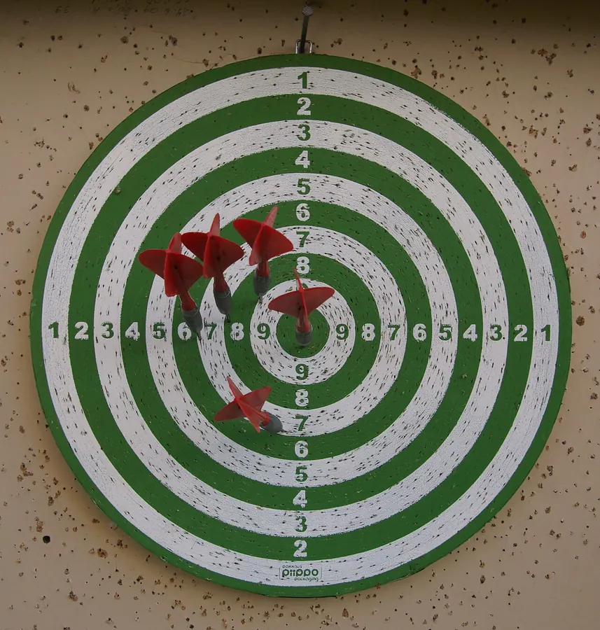 Darts clustered on a dartboard