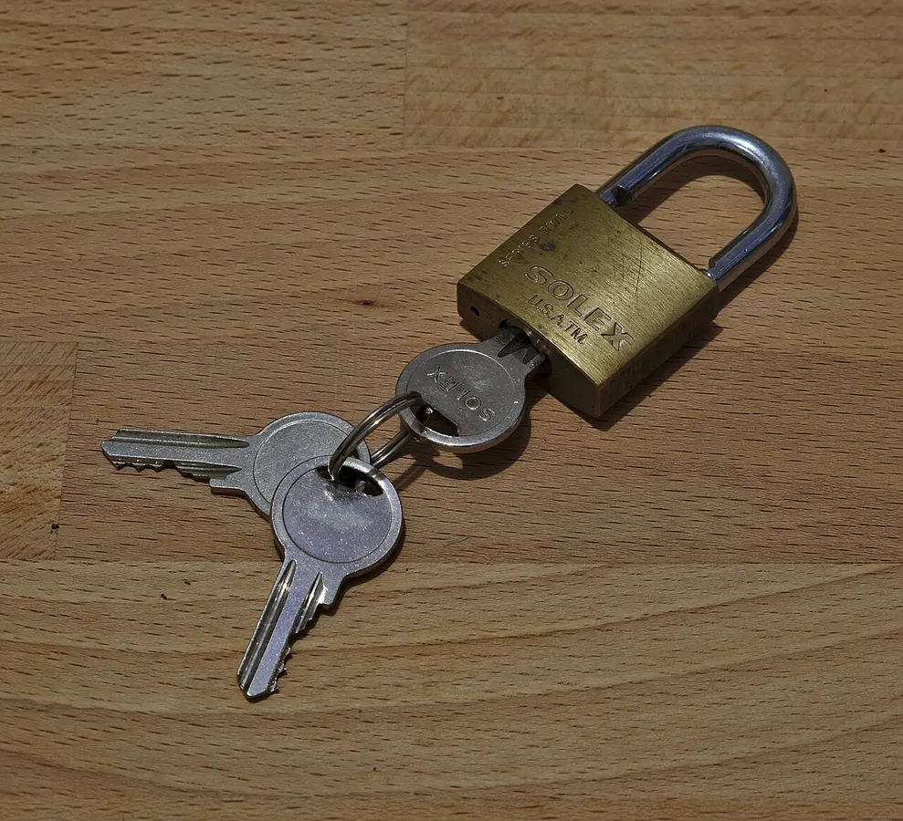 A brass padlock with its keys