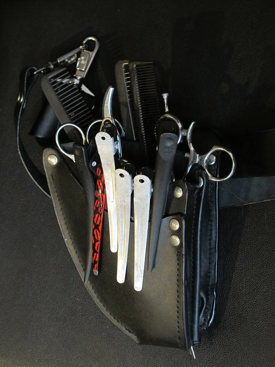 Hairdresser's holster filled with scissors and combs