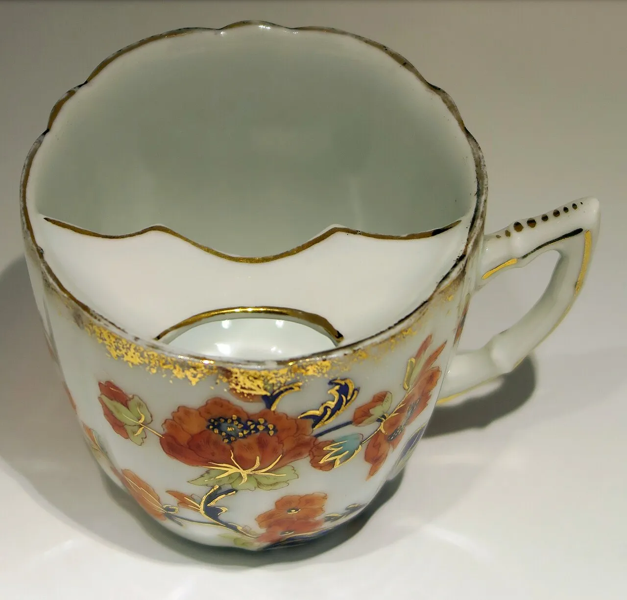 Antique porcelain moustache cup with a guard to keep the moustache dry