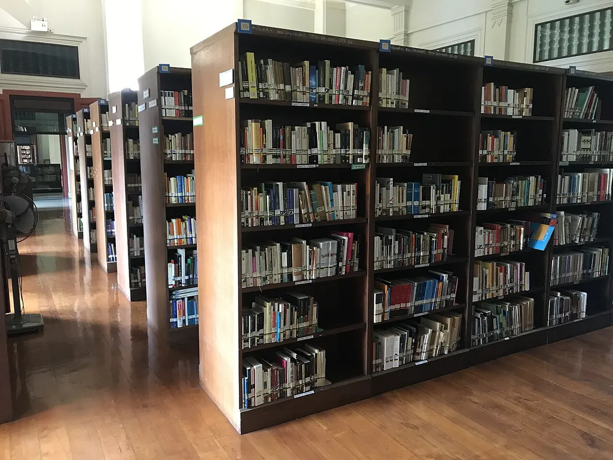 Rows of full bookshelves in a library