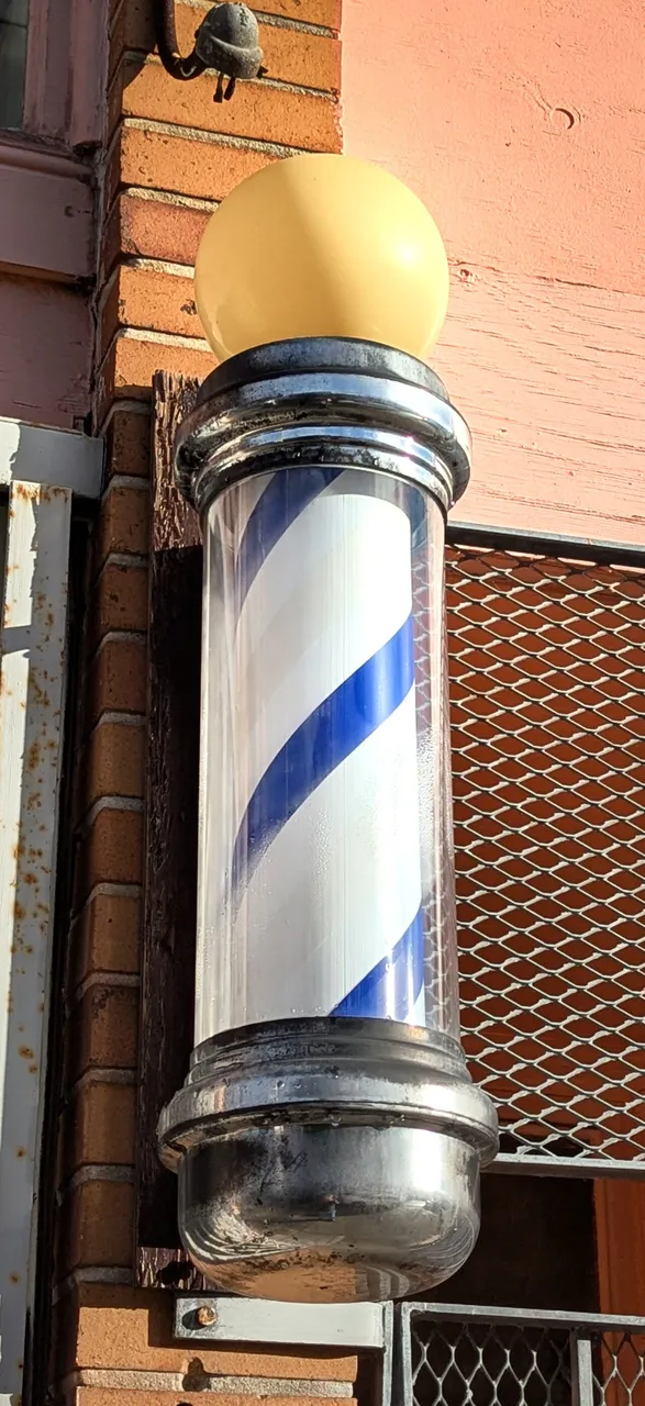 Spinning barber pole outside a barbershop