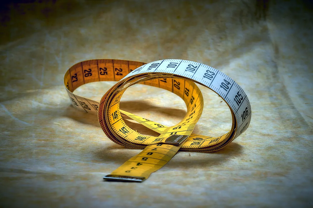 Coiled tailor's measuring tape on a cloth